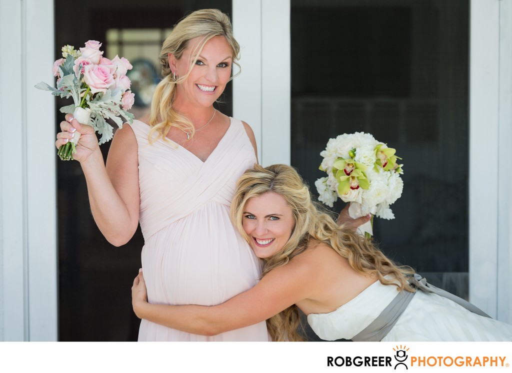 Bride Embraces Pregnant Maid of Honor