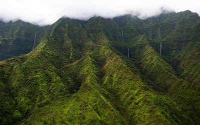 Aerial View of Cloud Topped Mountains & Waterfalls