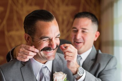 Getting Ready: Best Man Twirls Groom's Moustache