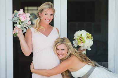 Bride Embraces Pregnant Maid of Honor