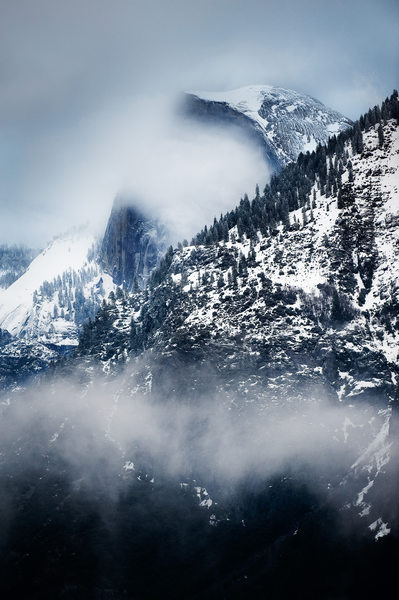Yosemite's Snowy Half Dome Shrouded in Winter Clouds